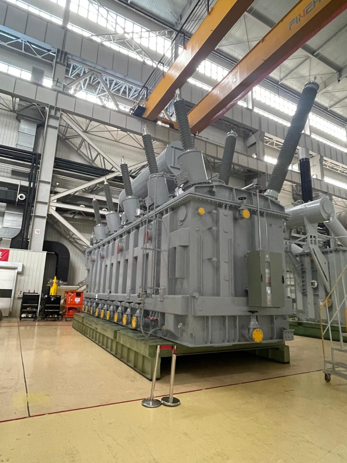 A large power transformer under assembly in a manufacturing hall