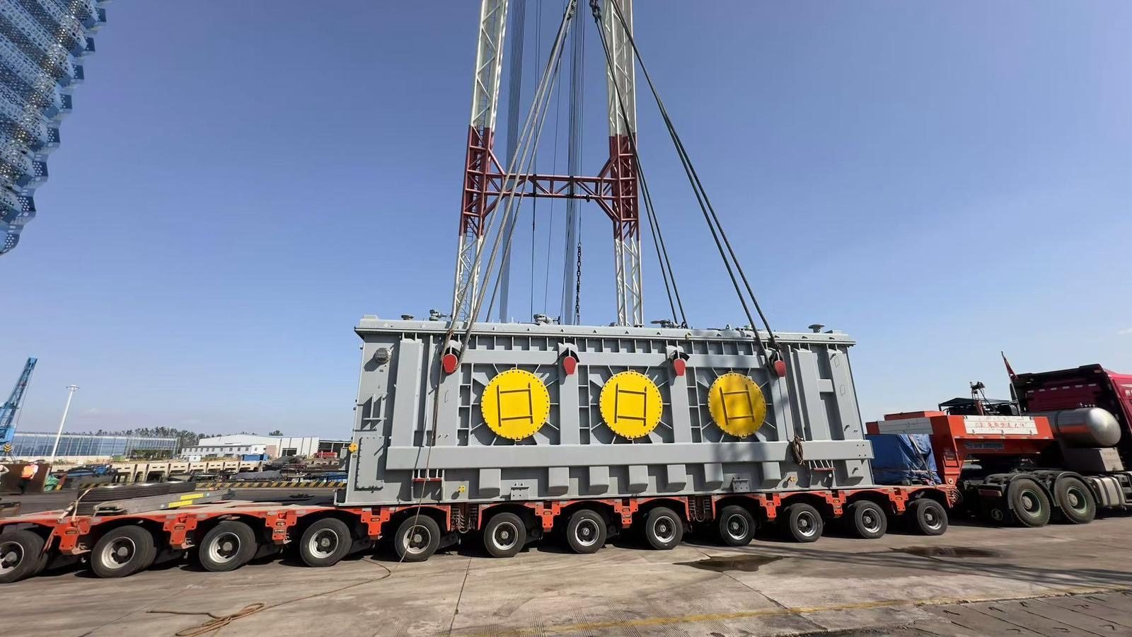 A transformer on a multi-axle self-propelled modular transporter at a port
