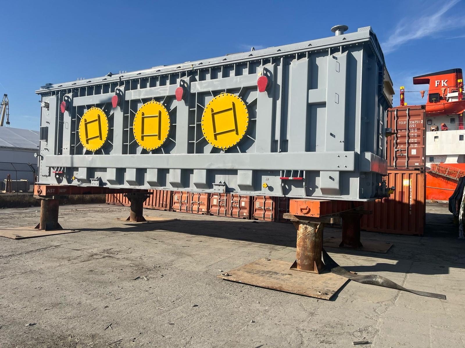 A power transformer on a transport frame at a port, radiator covers fitted